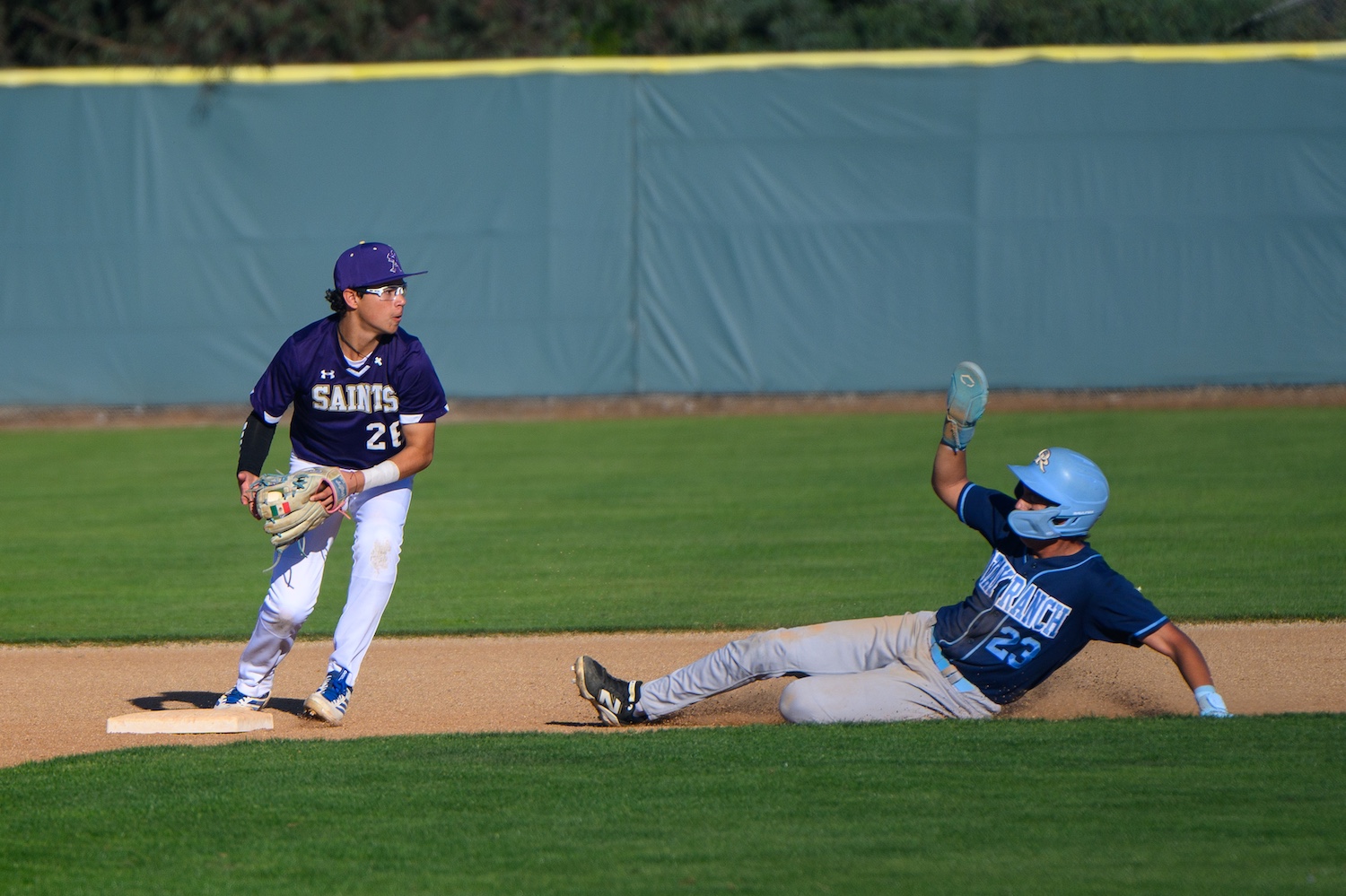 baseball player turning a double play at second base