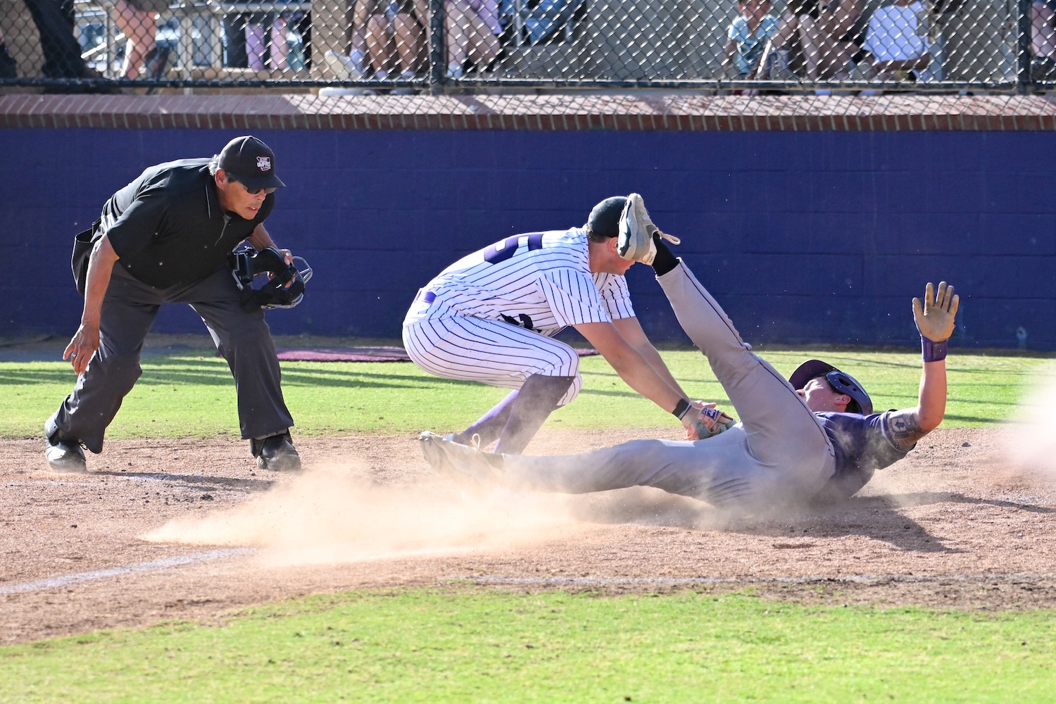baseball player thrown out at home plate by catcher